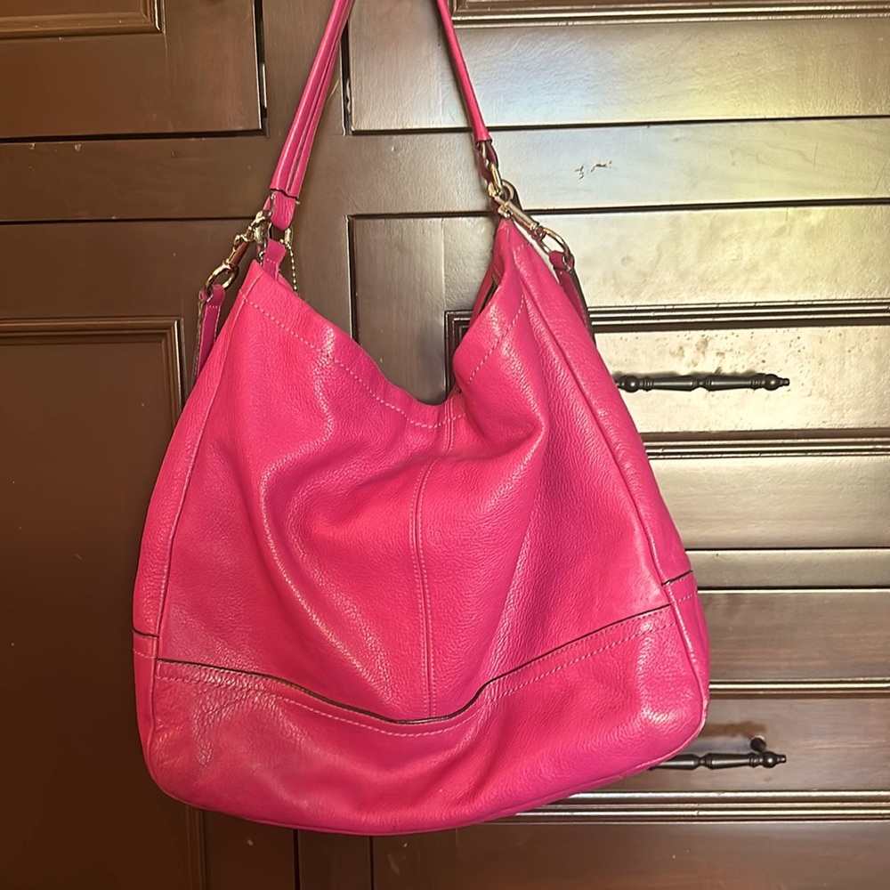 Large, deep pink coach bag. Used. A few scuffs on the bottom. Lots of life.